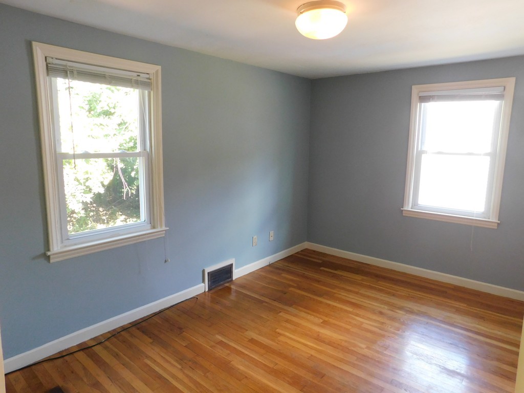 66 Notre Dame Street Springfield, MA 01104 - Photo 16 of 28 a view of an empty room with wooden floor and a window
