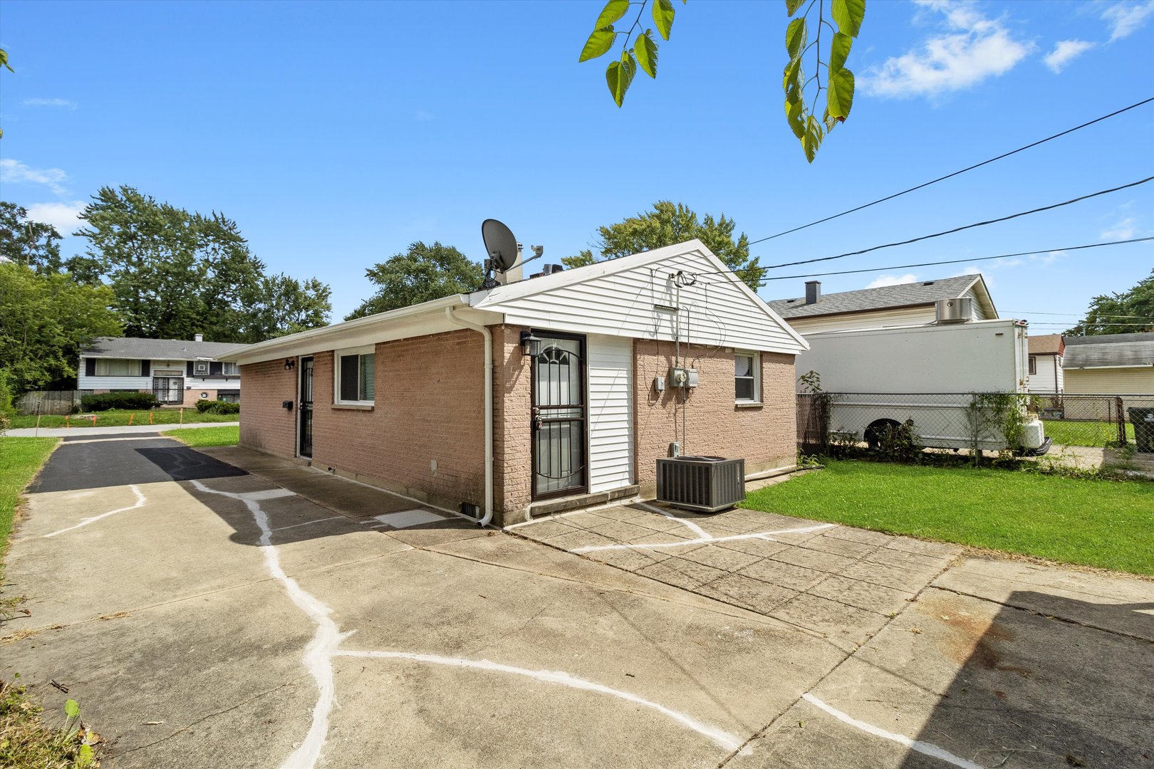 16510 Marshfield Avenue Markham, IL 60428 - Photo 37 of 38 a front view of a house with a yard and garage