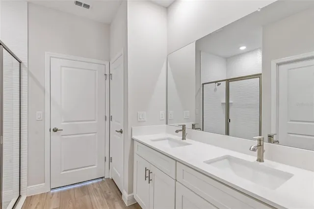 a bathroom with 2 sink and a mirror