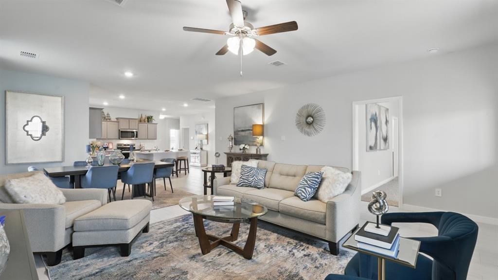 1205 Tree House Lane Decatur, TX 76234 - Photo 14 of 35 a living room with furniture kitchen view and a chandelier