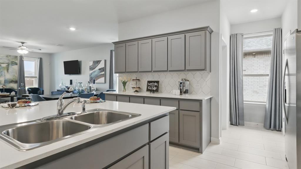 1205 Tree House Lane Decatur, TX 76234 - Photo 2 of 35 a kitchen with a sink cabinets and utility