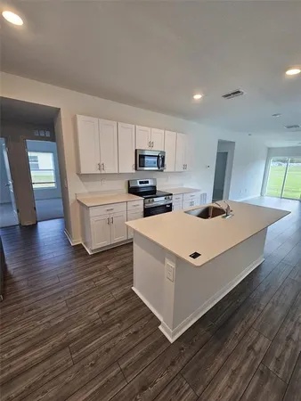 a kitchen with a stove and a refrigerator