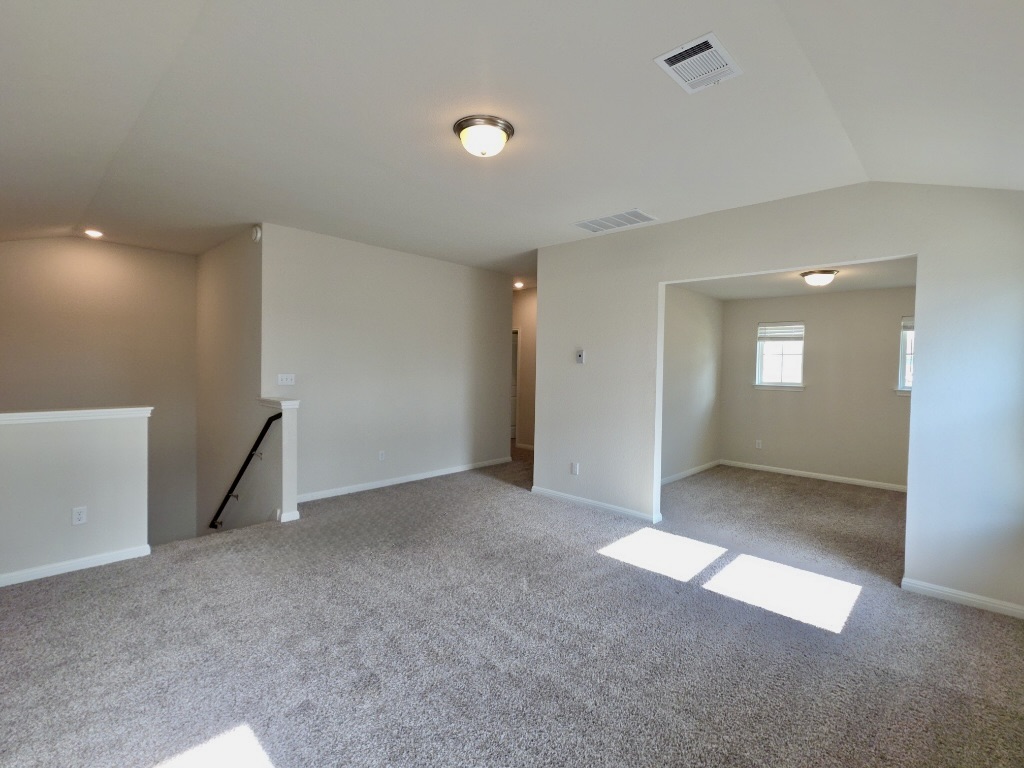 110 Grapefruit Road Hutto, TX 78634 - Photo 16 of 28 Carpeted open area with light-colored walls