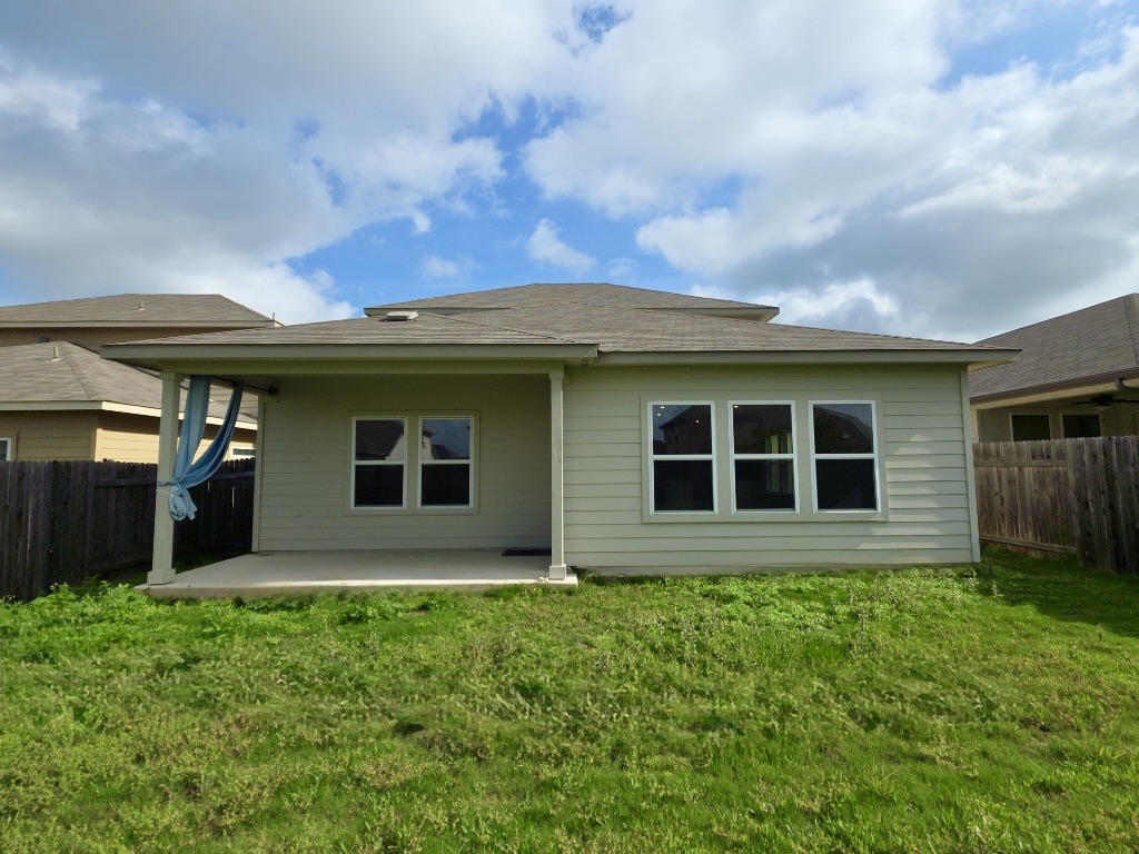 110 Grapefruit Road Hutto, TX 78634 - Photo 28 of 28 Rear exterior featuring a covered concrete patio, horizontal siding, multiple windows, and a shingle roof