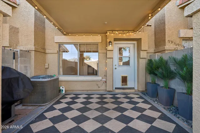 a front view of a house with a black white checkered floor