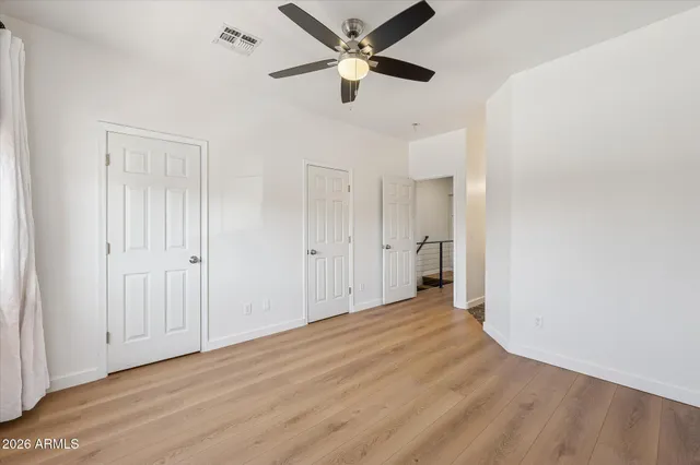 a view of an empty room and a ceiling fan
