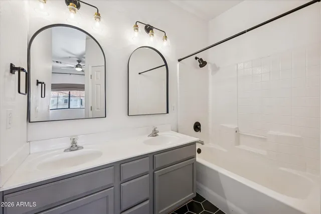 a bathroom with a tub a sink and mirror