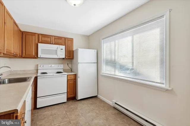 a kitchen with a stove a refrigerator and a sink
