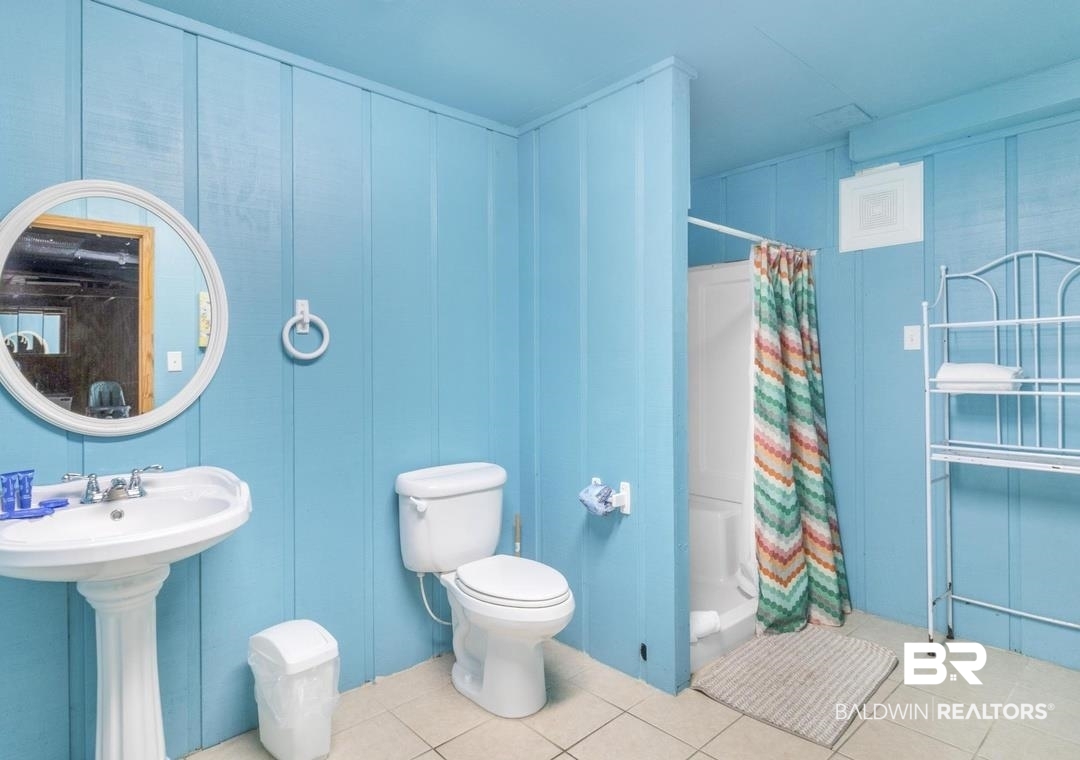 26318 Marina Road Orange Beach, AL 36561 - Photo 34 of 38 Full bathroom featuring a stall shower and light tile patterned floors