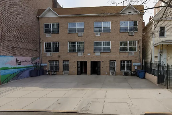 a view of a brick building with many windows