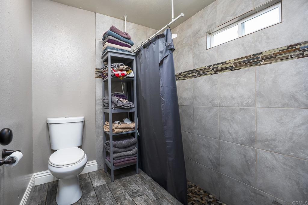 2430 Geyer Lane Alpine, CA 91901 - Photo 25 of 60 a bathroom with a toilet and a shower