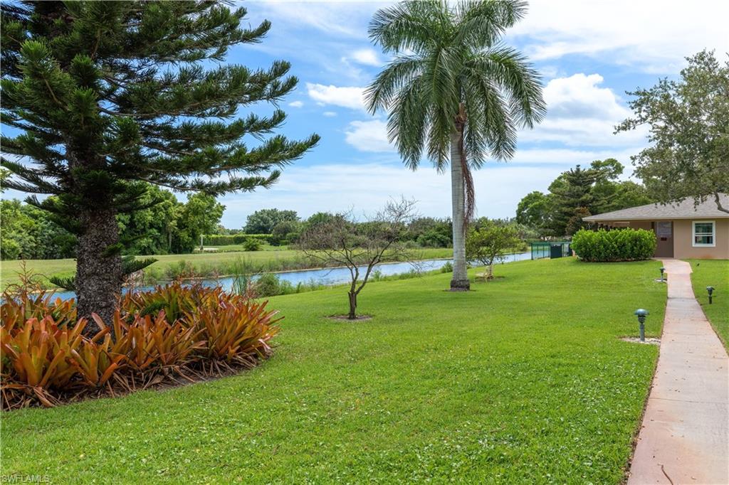 5467 Rattlesnake Hammock Road, Unit 202C Naples, FL 34113 - Photo 13 of 18 a view of swimming pool and garden