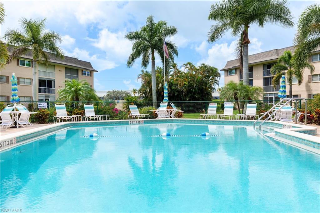 5467 Rattlesnake Hammock Road, Unit 202C Naples, FL 34113 - Photo 14 of 18 a view of a swimming pool and a chair