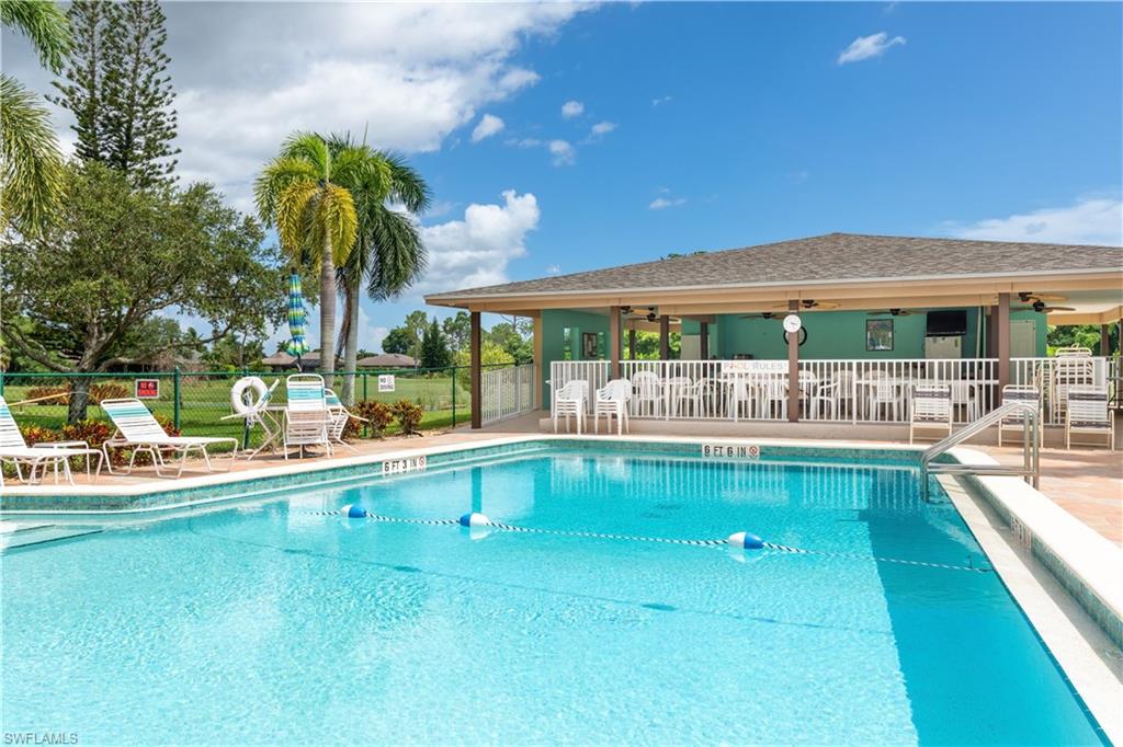 5467 Rattlesnake Hammock Road, Unit 202C Naples, FL 34113 - Photo 15 of 18 a view of swimming pool with outdoor seating