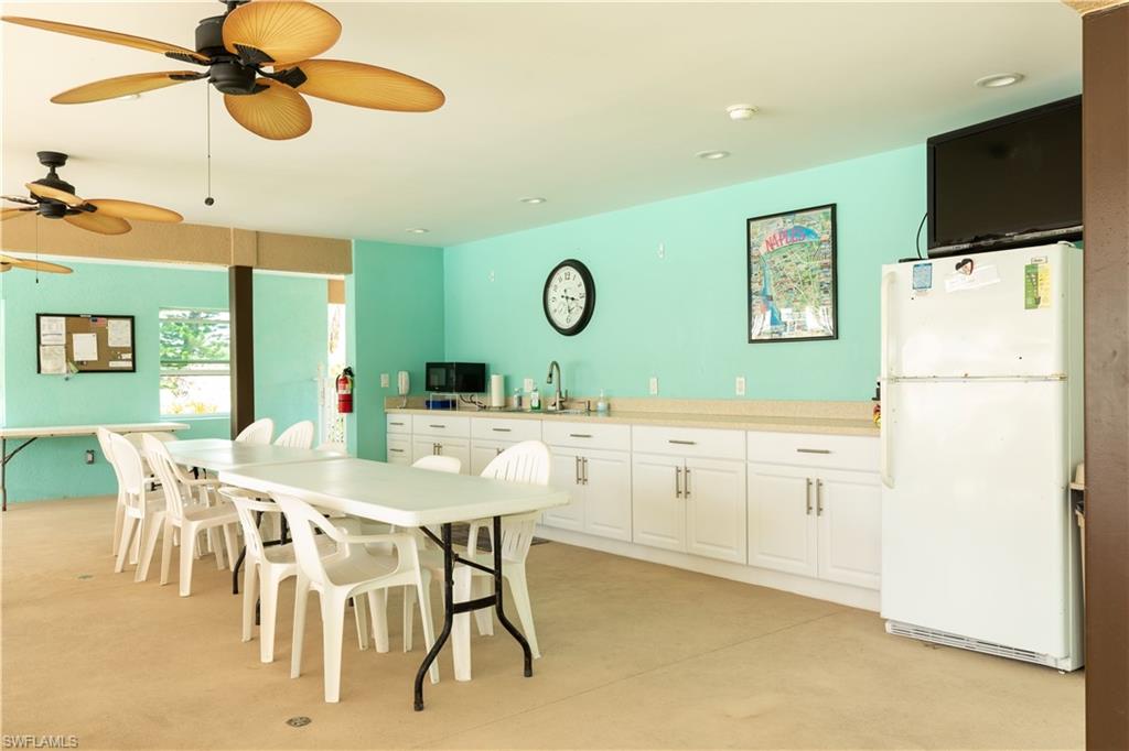 5467 Rattlesnake Hammock Road, Unit 202C Naples, FL 34113 - Photo 16 of 18 a kitchen with a refrigerator and countertop