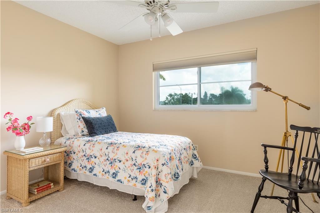 5467 Rattlesnake Hammock Road, Unit 202C Naples, FL 34113 - Photo 7 of 18 a bedroom with a bed and a window