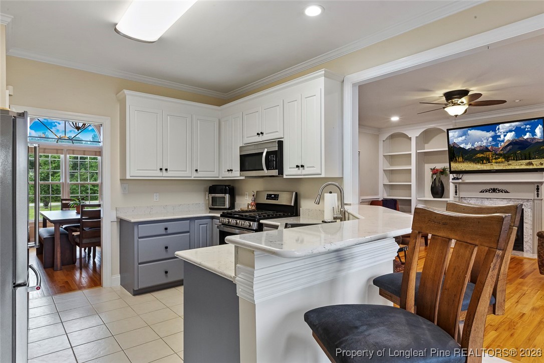 514 Averette Road Rolesville, NC 27571 - Photo 14 of 38 a kitchen with stainless steel appliances granite countertop a stove top oven a sink a dining table and chairs