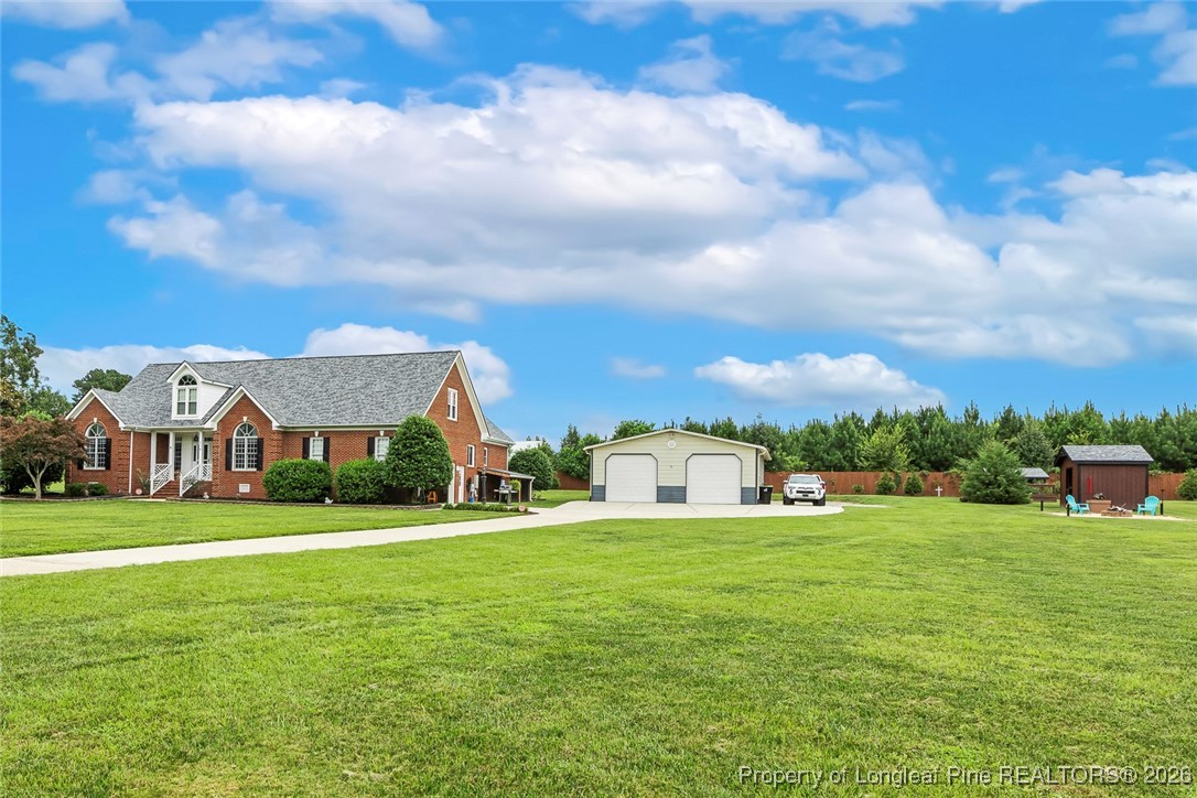 514 Averette Road Rolesville, NC 27571 - Photo 2 of 38 a view of a house with a big yard and large trees