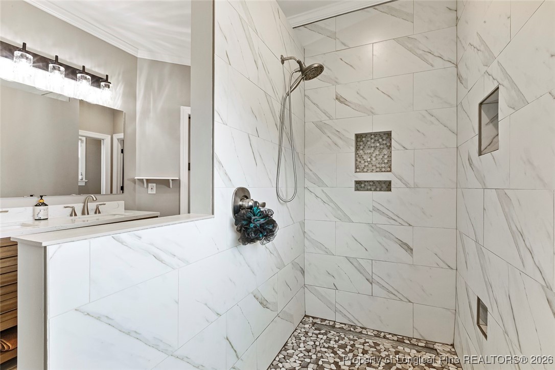 514 Averette Road Rolesville, NC 27571 - Photo 21 of 38 a bathroom with a sink a mirror and shower