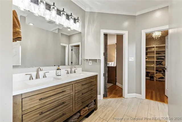 a bathroom with a double vanity sink and a mirror
