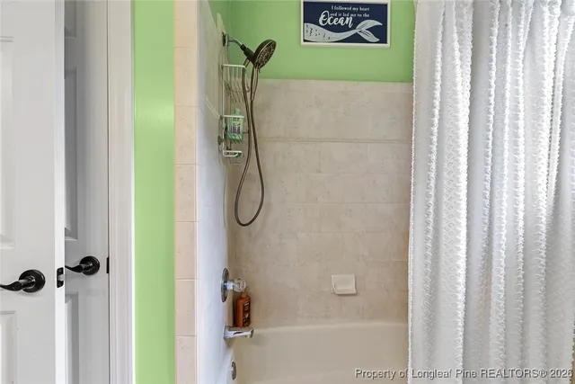 a bathroom with a shower and a shower