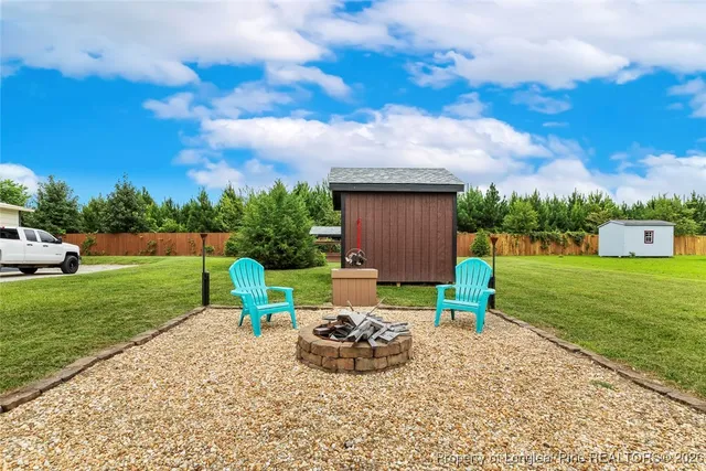 a view of a house with a yard and a garden