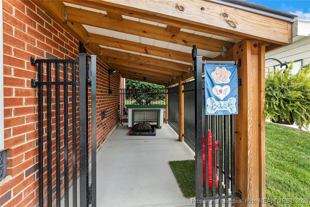 514 Averette Road Rolesville, NC 27571 - Photo 37 of 38 a view of a porch with a table and chairs and potted plants