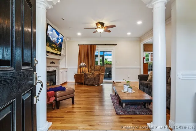 a living room with fireplace furniture and a flat screen tv