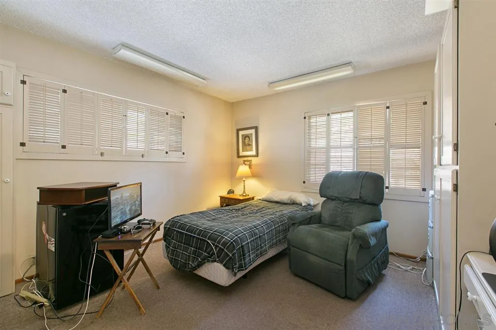 3729 Sinclair Lane Spring Valley, CA 91977 - Photo 17 of 24 a bedroom with furniture and a fireplace