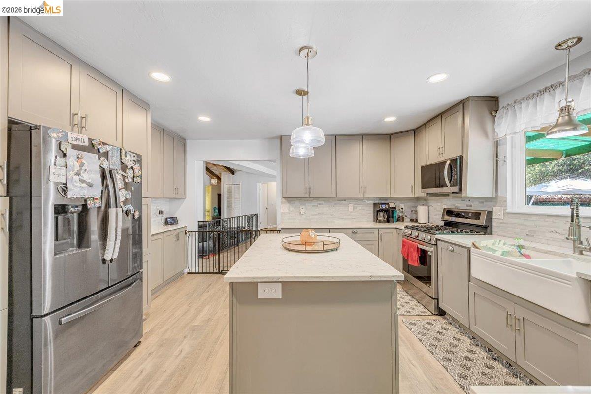8733 Fraguero Road Sonora, CA 95370 - Photo 32 of 73 Kitchen featuring light gray cabinetry, stainless steel appliances, a white farmhouse sink, light wood-finish flooring, and recessed lighting