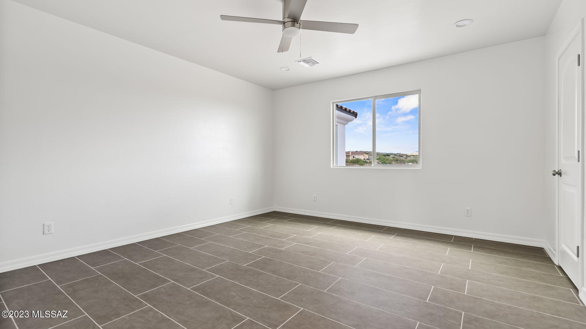 1019 Paseo Guebabi Rio Rico, AZ 85648 - Photo 22 of 25 an empty room with windows and fan