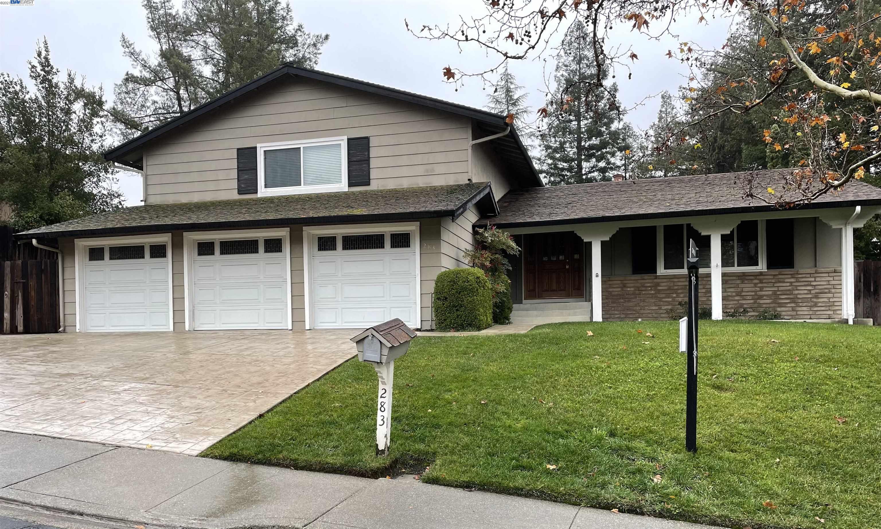a front view of a house with a garden