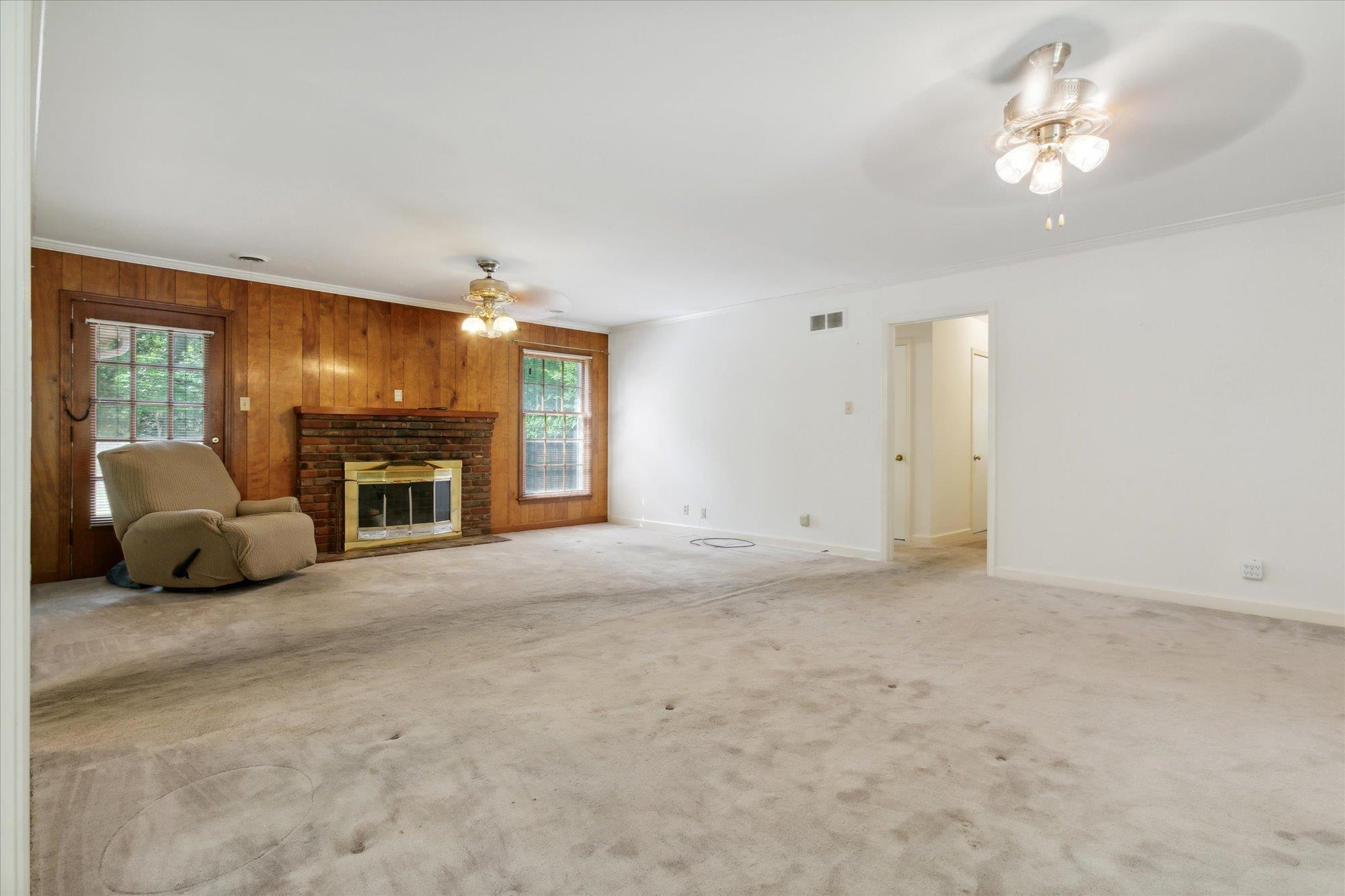 6173 Ivanhoe Road Bartlett, TN 38134 - Photo 11 of 35 a view of a livingroom with a fireplace a chandelier and windows