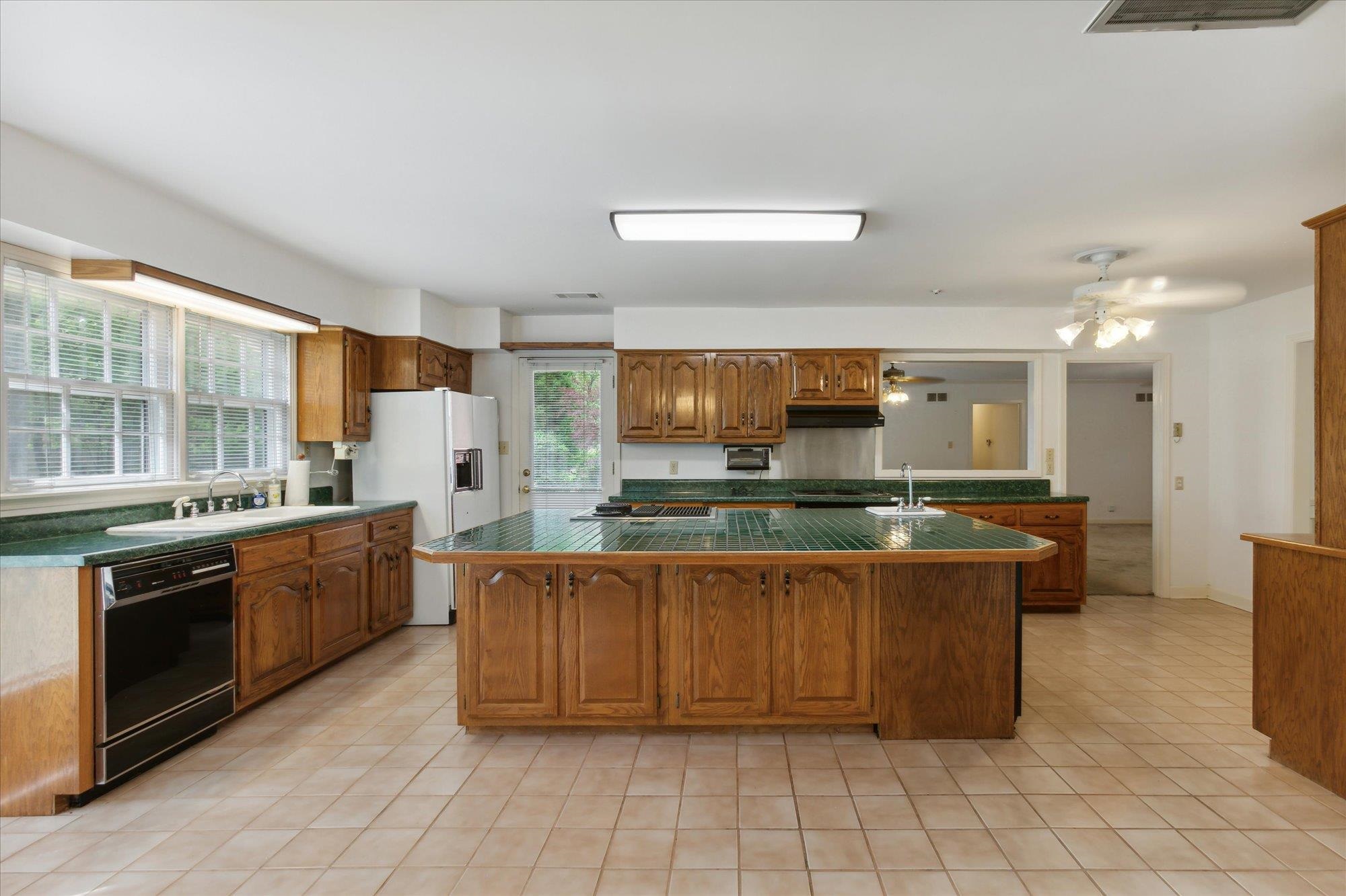 6173 Ivanhoe Road Bartlett, TN 38134 - Photo 19 of 35 a large kitchen with stainless steel appliances granite countertop a stove and a sink