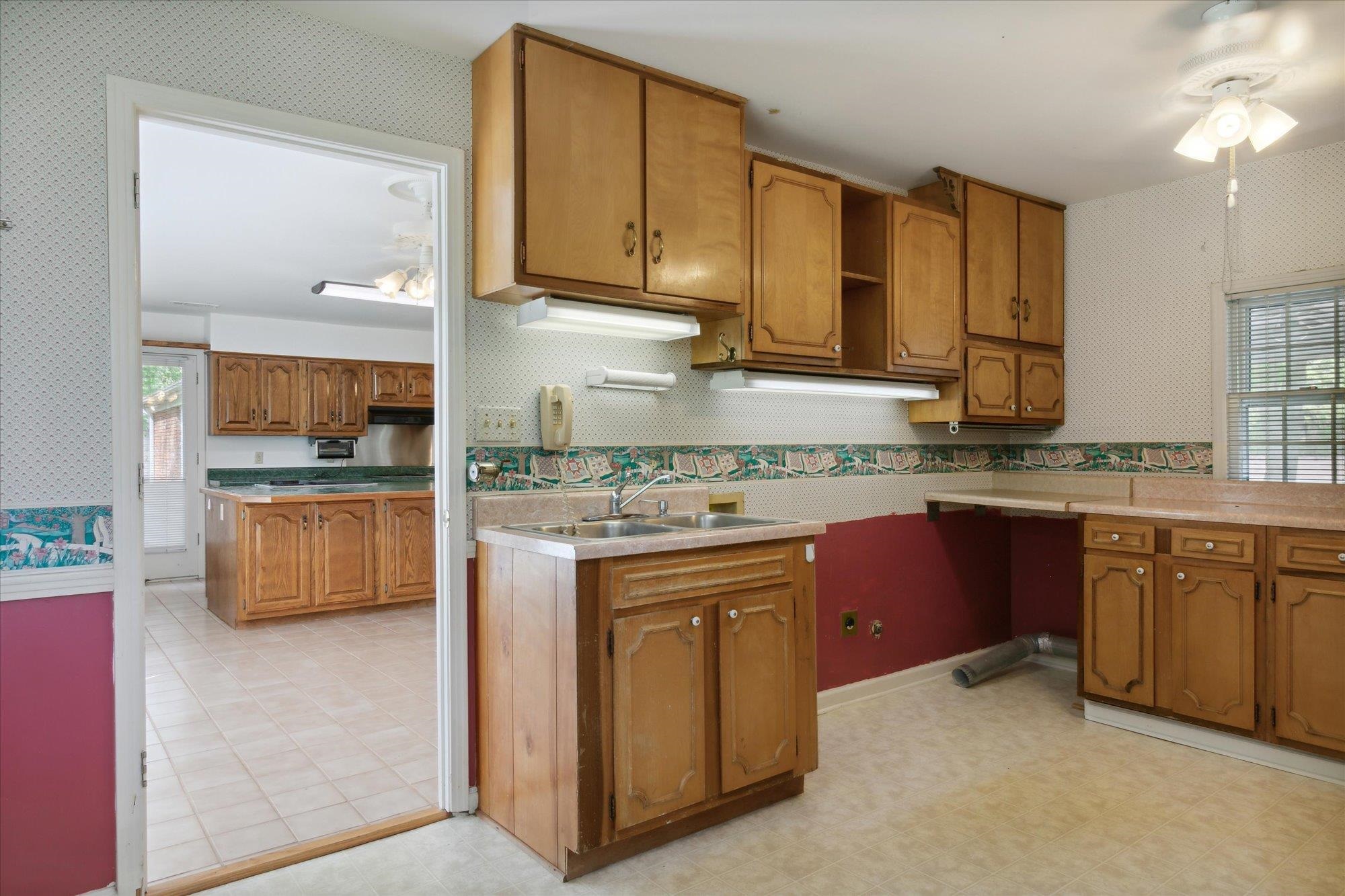 6173 Ivanhoe Road Bartlett, TN 38134 - Photo 21 of 35 a kitchen with kitchen island granite countertop a sink stove and cabinets