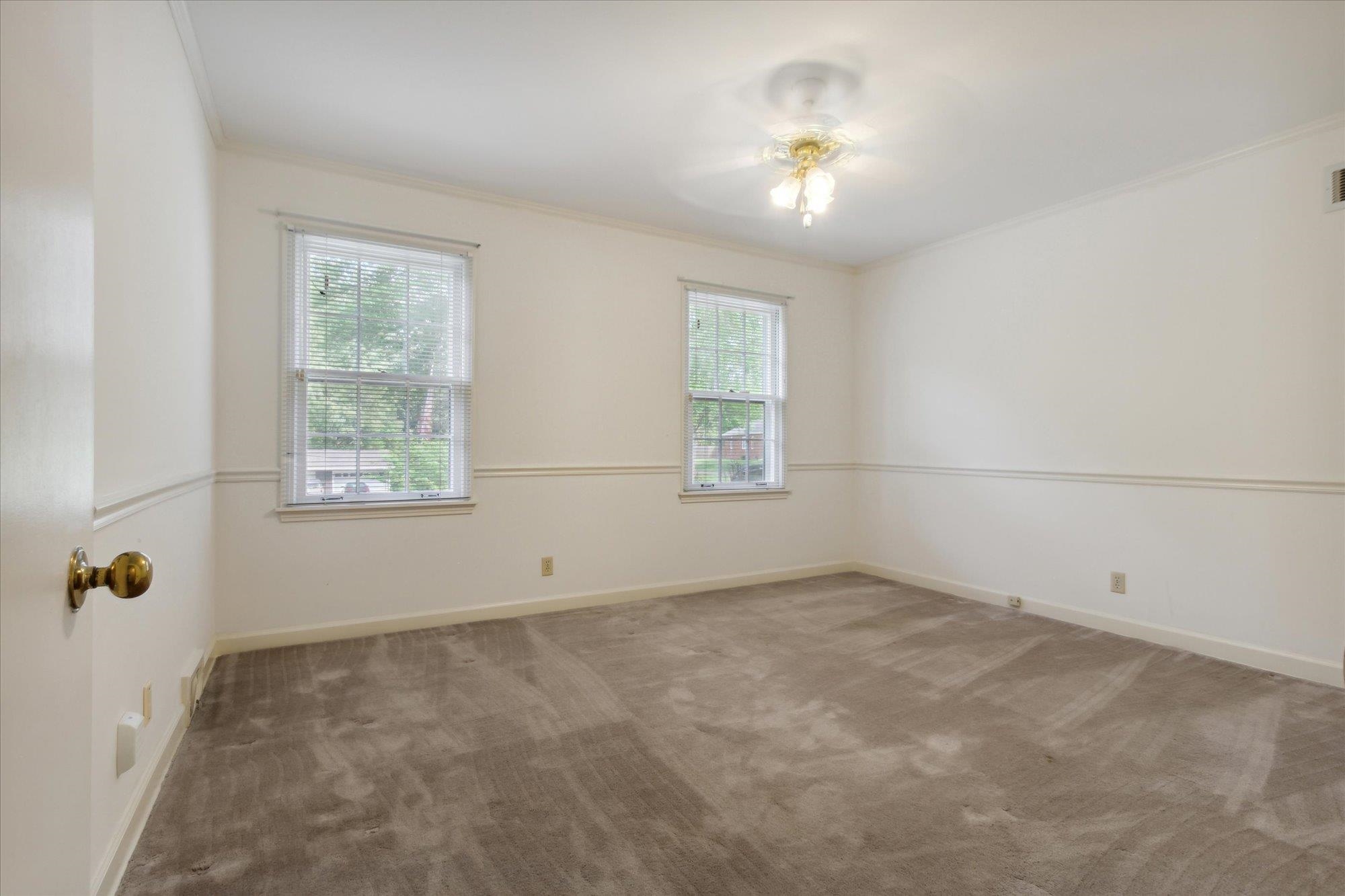 6173 Ivanhoe Road Bartlett, TN 38134 - Photo 25 of 35 an empty room with windows and chandelier fan