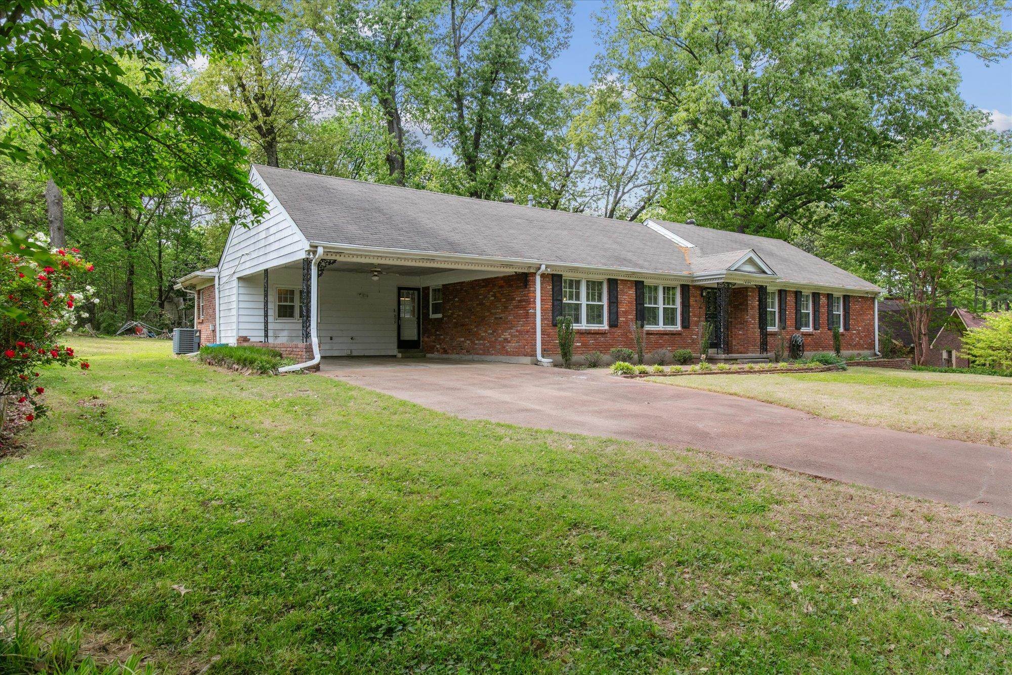 6173 Ivanhoe Road Bartlett, TN 38134 - Photo 3 of 35 a front view of a house with a yard and green space