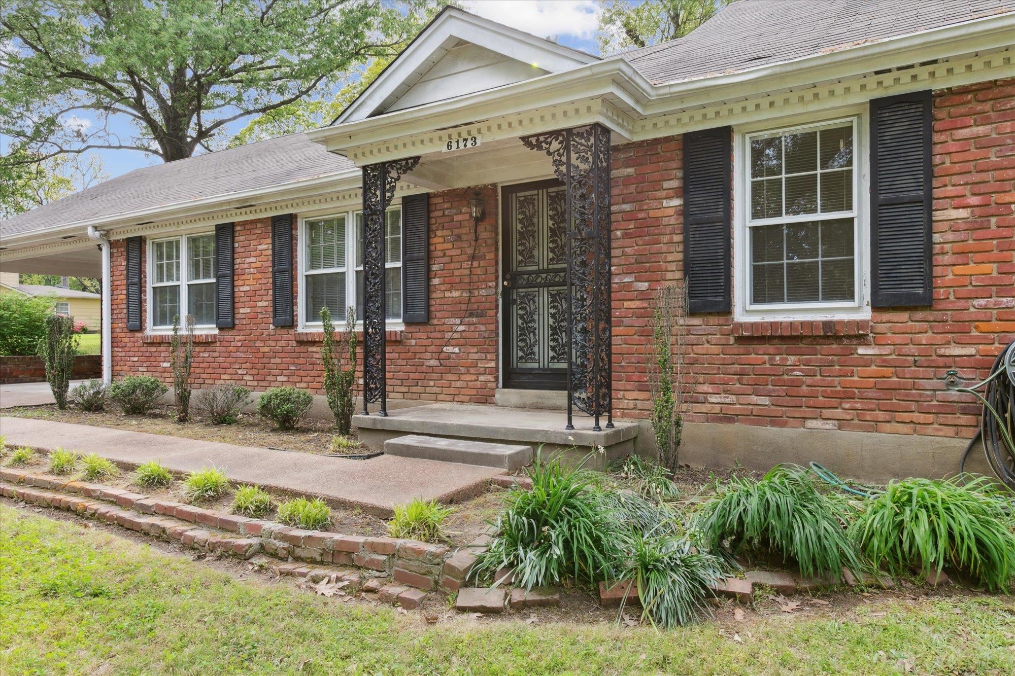 6173 Ivanhoe Road Bartlett, TN 38134 - Photo 4 of 35 a front view of a house with garden