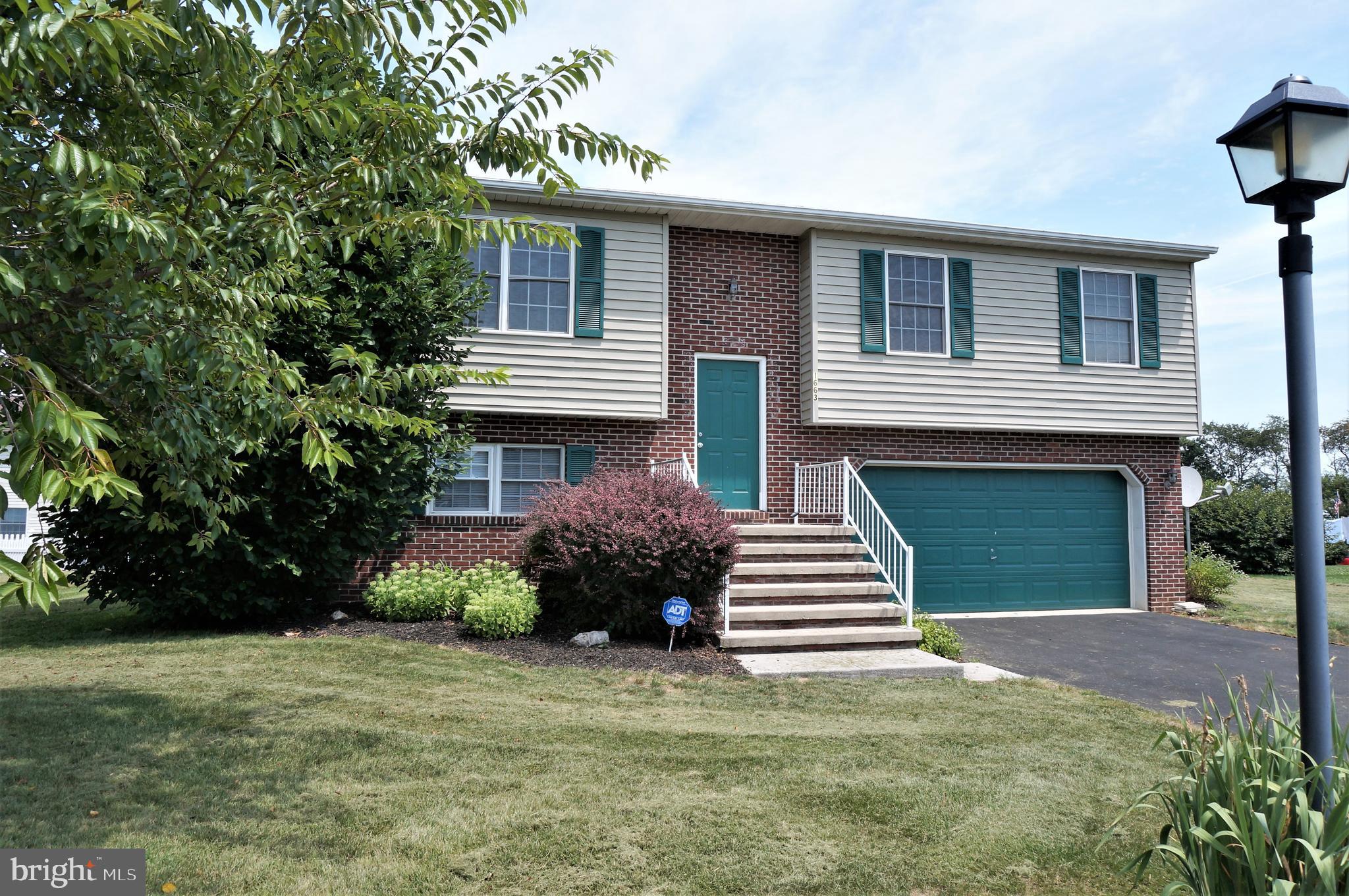 1663 Taylor Drive Hanover, PA 17331 - Photo 2 of 29 a front view of a house with a garden