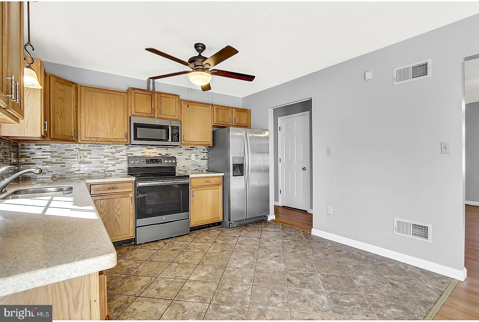 1663 Taylor Drive Hanover, PA 17331 - Photo 11 of 29 a kitchen with granite countertop a refrigerator a sink a stove top oven a cabinetry and a window