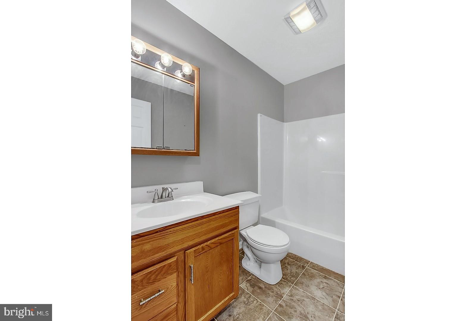 1663 Taylor Drive Hanover, PA 17331 - Photo 20 of 29 a bathroom with a granite countertop toilet sink and mirror