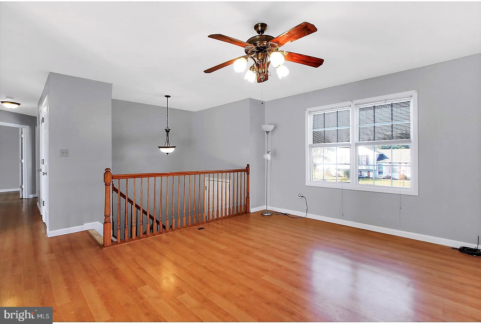 1663 Taylor Drive Hanover, PA 17331 - Photo 6 of 29 a view of an empty room with a window and wooden floor