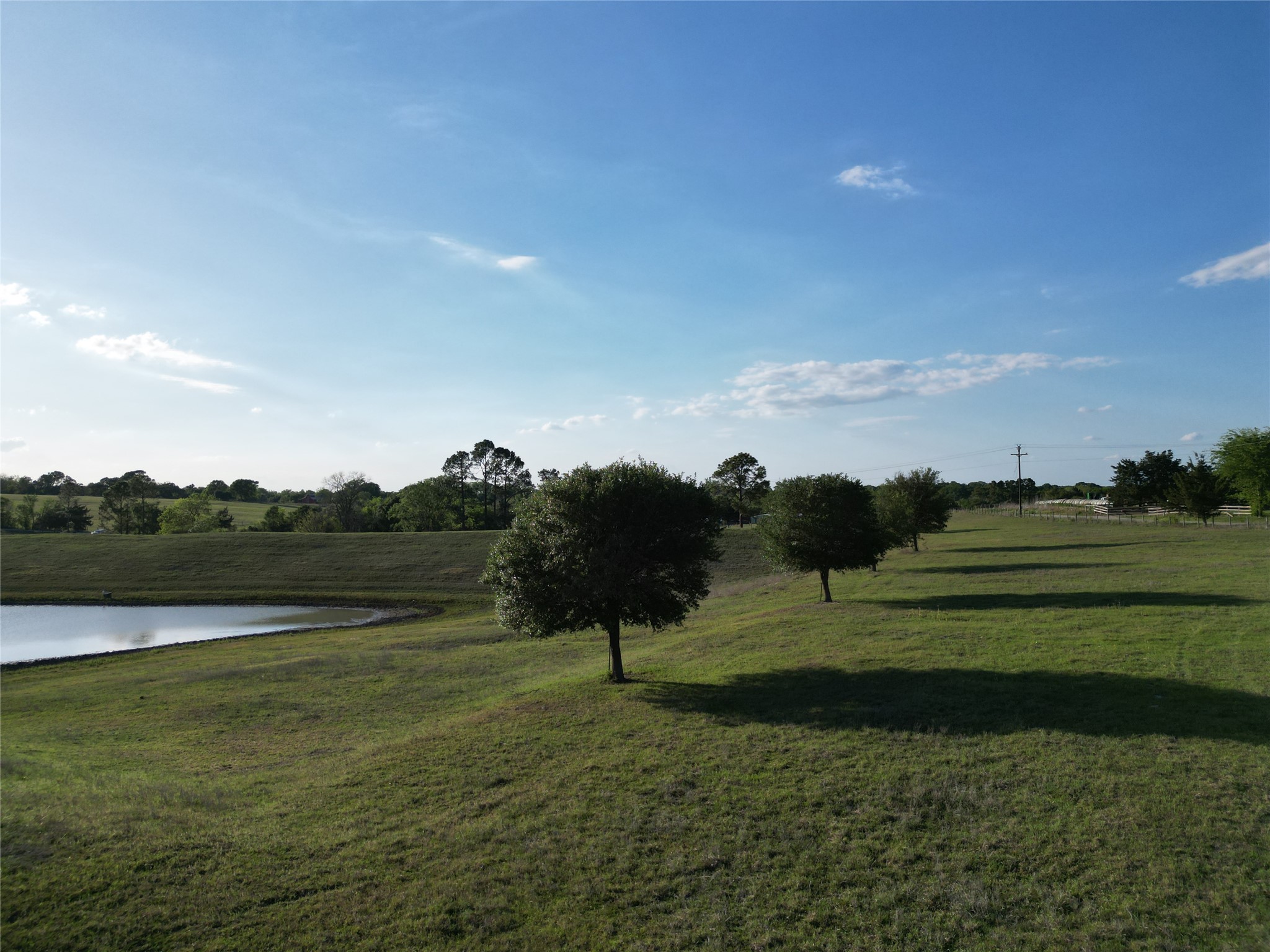 2525 North Meyersville Road Brenham, TX 77833 - Photo 7 of 22 a view of a golf course with a lake