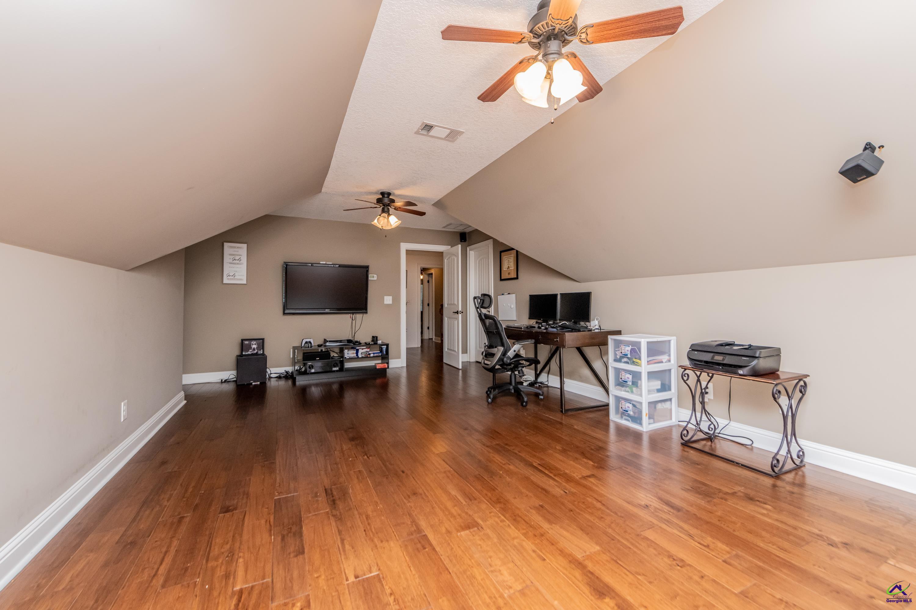 405 Old Bridge Road Warner Robins, GA 31088 - Photo 42 of 58 a living room with furniture and a wooden floor
