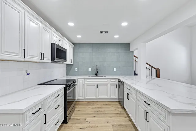 a kitchen with granite countertop a stove and a sink