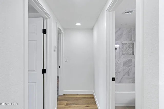 a bathroom with a granite countertop sink a toilet and shower