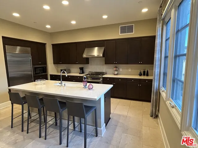a kitchen with stainless steel appliances granite countertop a sink counter space and cabinets