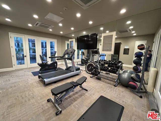 a view of a swimming pool with lawn chairs under palm trees