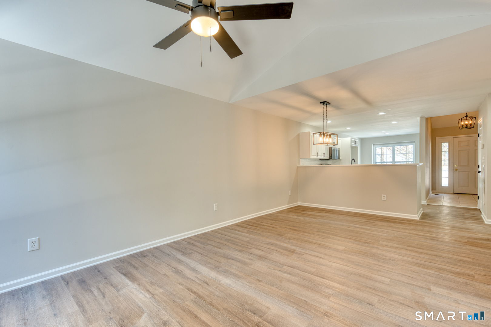 159 Jennifer Lane, Unit 159 Newtown, CT 06482 - Photo 11 of 32 an empty room with wooden floor and windows