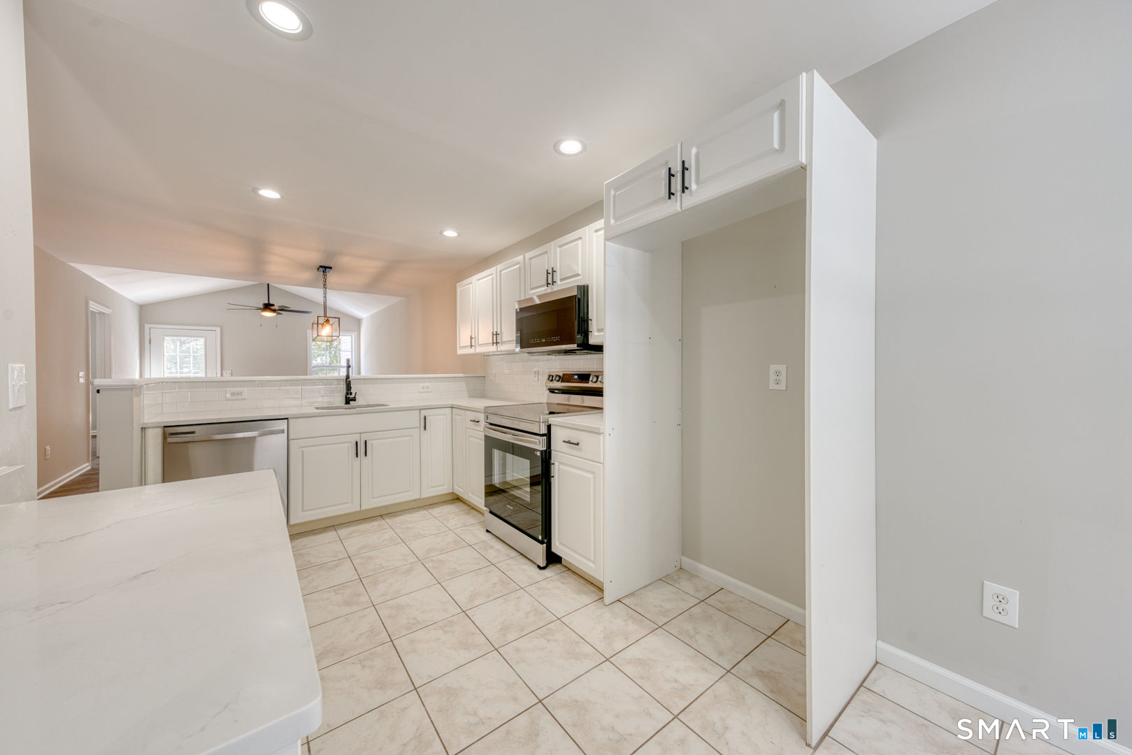 159 Jennifer Lane, Unit 159 Newtown, CT 06482 - Photo 17 of 32 a kitchen with white cabinets stainless steel appliances and sink